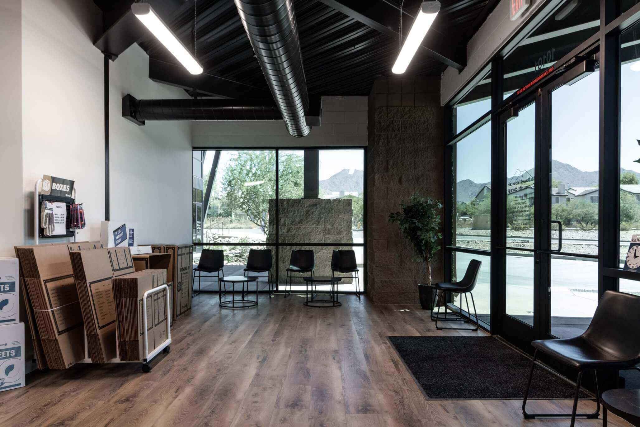 Neatly organized storage unit with labeled containers and furniture during a home renovation in Scottsdale, AZ at McDowell Mountain Community Storage