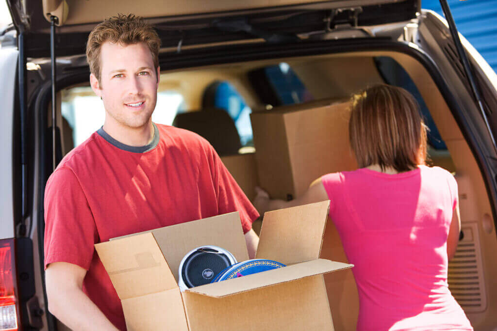 Neatly organized storage unit with labeled containers and furniture during a home renovation in Scottsdale, AZ at McDowell Mountain Community Storage