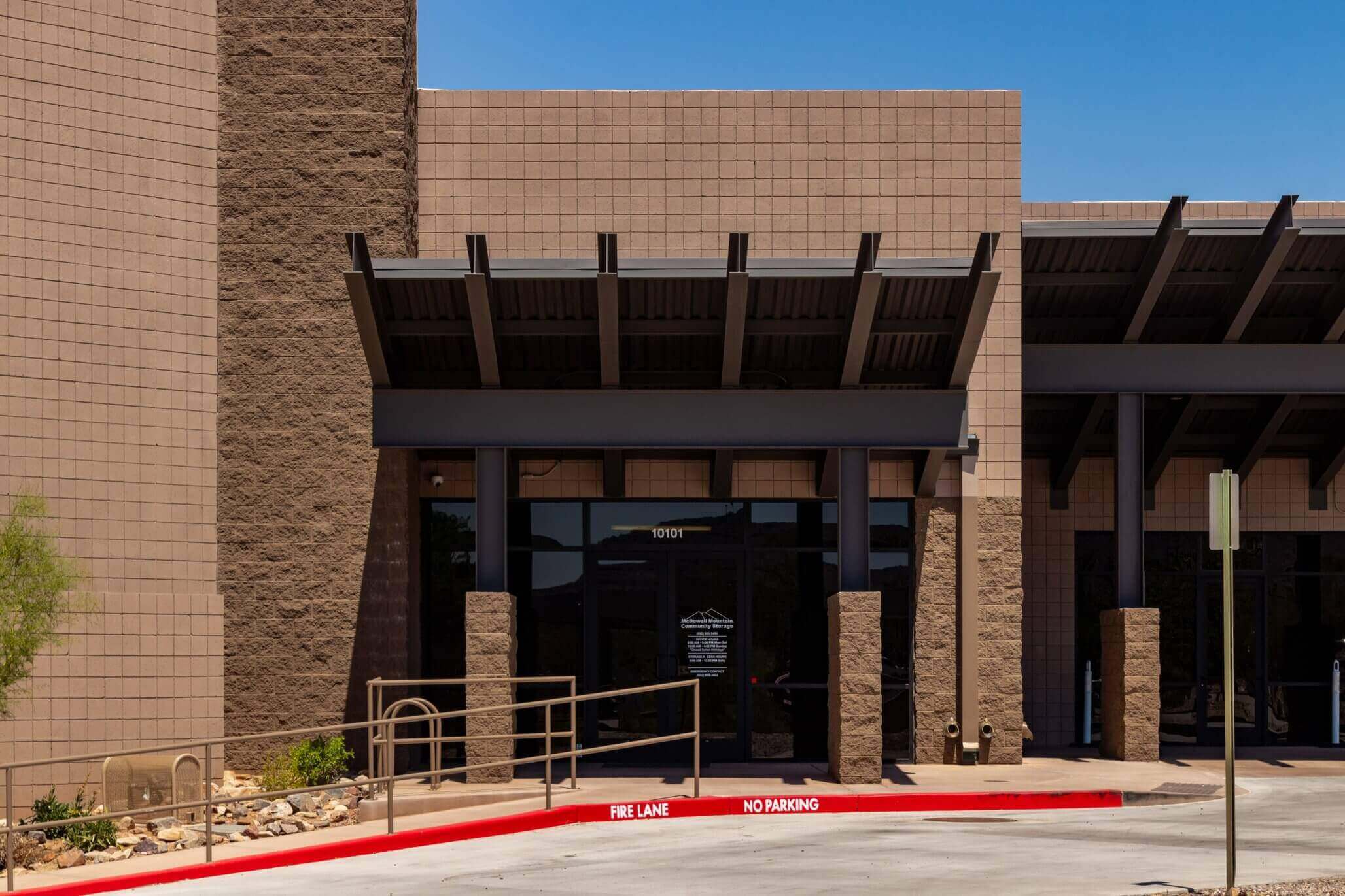 Small storage unit neatly organized with labeled boxes shelves and containers at McDowell Mountain Community Storage in Scottsdale Arizona
